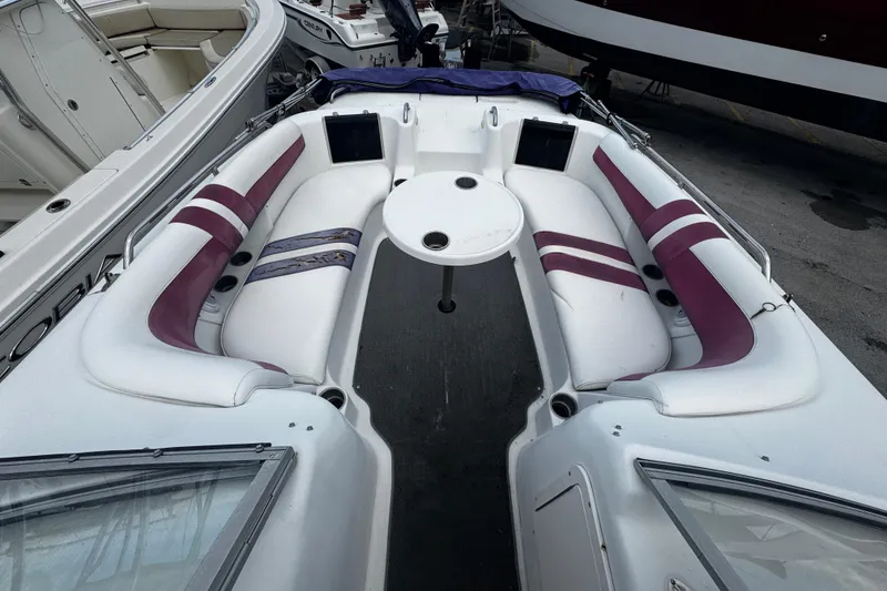 Slide: The Image of 2008 Splendor 240 Sunstar boat interior with white and purple seating and round table. - 6