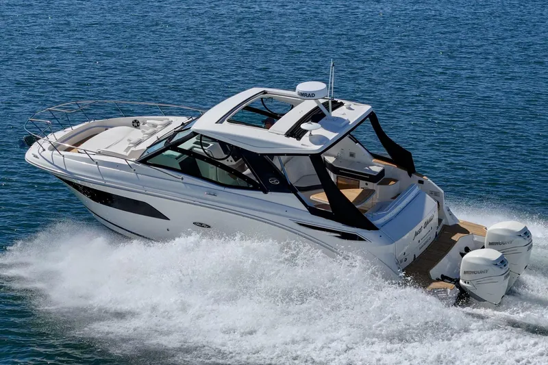 Slide: The Image of 2021 Sea Ray Sundancer 320 Outboard cruising on open water. - 12