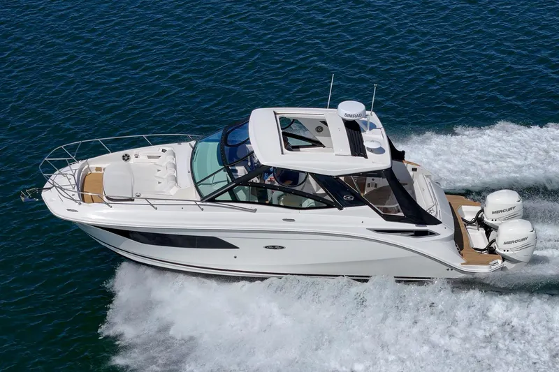 Slide: The Image of 2021 Sea Ray Sundancer 320 Outboard cruising on open water. - 13