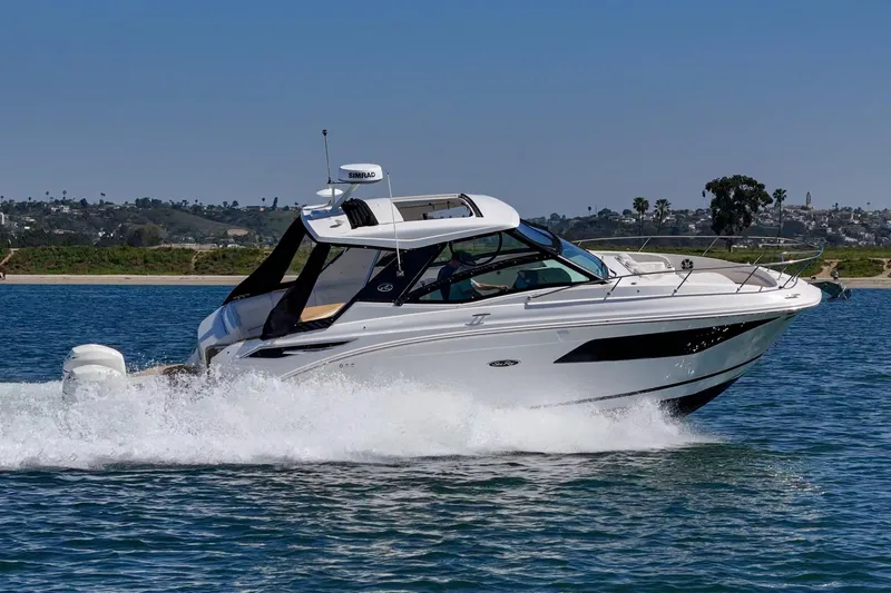 Slide: The Image of 2021 Sea Ray Sundancer 320 Outboard cruising on open water. - 14