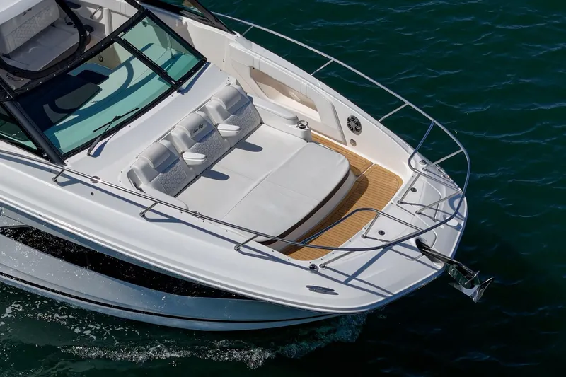 Slide: The Image of 2021 Sea Ray Sundancer 320 Outboard cruising on water, showcasing sleek design and spacious deck. - 18