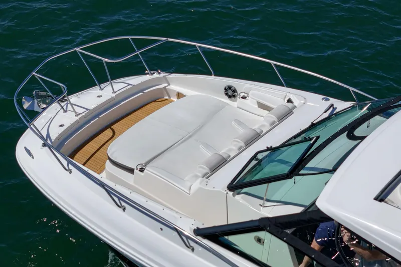 Slide: The Image of 2021 Sea Ray Sundancer 320 Outboard boat with spacious deck and seating on water. - 19