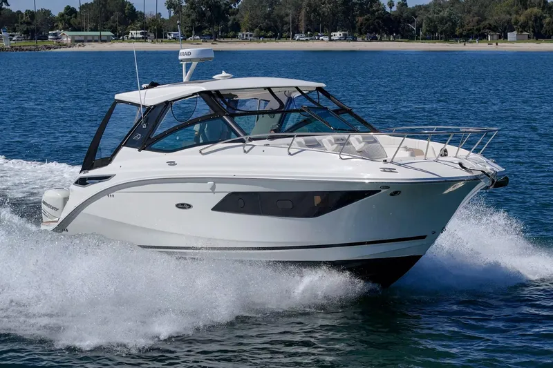 Slide: The Image of 2021 Sea Ray Sundancer 320 Outboard cruising on a sunny day. - 2