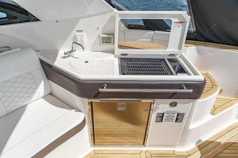 Slide: The Image of Luxury outdoor kitchen on 2021 Sea Ray Sundancer 320 Outboard yacht with grill and sink. - 30