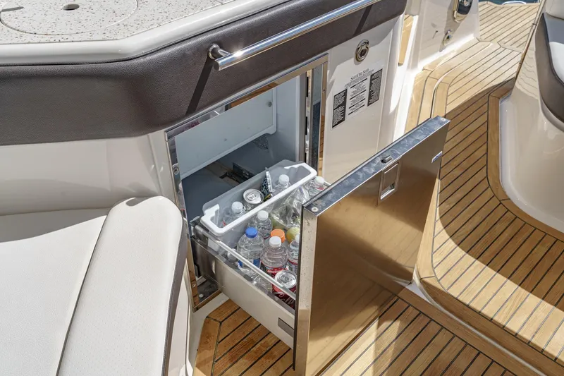 Slide: The Image of 2021 Sea Ray Sundancer 320 Outboard boat with open mini fridge stocked with beverages. - 31