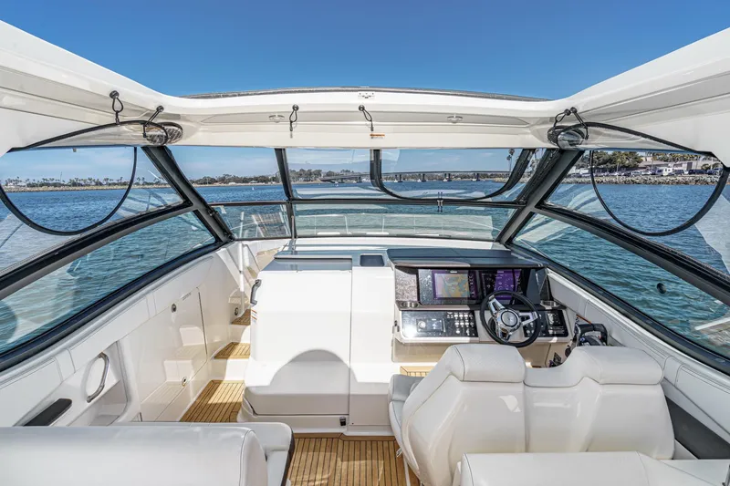 Slide: The Image of 2021 Sea Ray Sundancer 320 Outboard cockpit with modern controls and panoramic water view. - 33