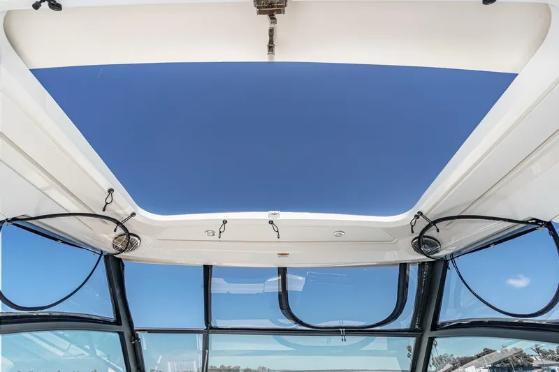Slide: The Image of 2021 Sea Ray Sundancer 320 Outboard sunroof view with clear blue sky. - 34