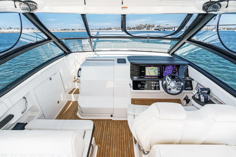 Slide: The Image of 2021 Sea Ray Sundancer 320 Outboard cockpit with modern navigation system and luxurious seating. - 35