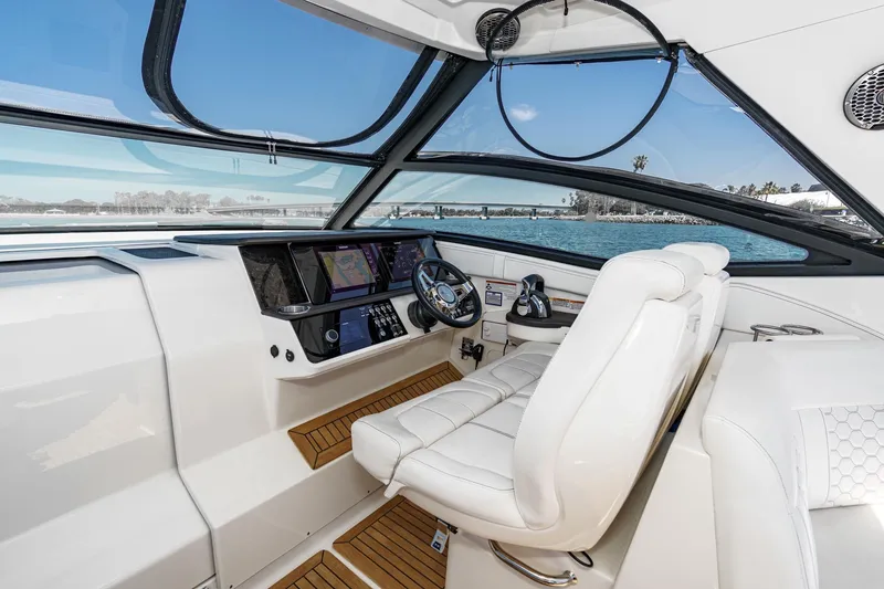 Slide: The Image of 2021 Sea Ray Sundancer 320 Outboard helm with modern controls and panoramic view. - 36