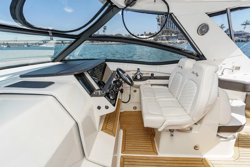 Slide: The Image of Interior of 2021 Sea Ray Sundancer 320 Outboard with luxurious seating and modern dashboard. - 37