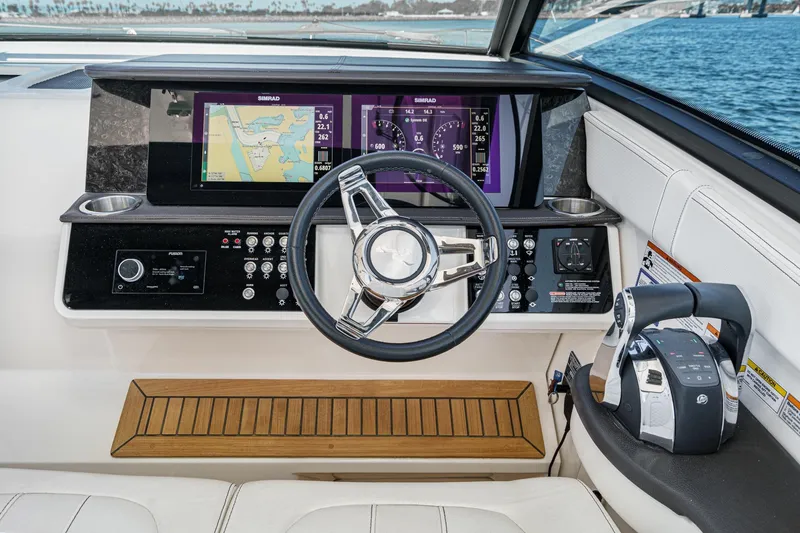 Slide: The Image of 2021 Sea Ray Sundancer 320 Outboard helm with advanced navigation displays and controls. - 38
