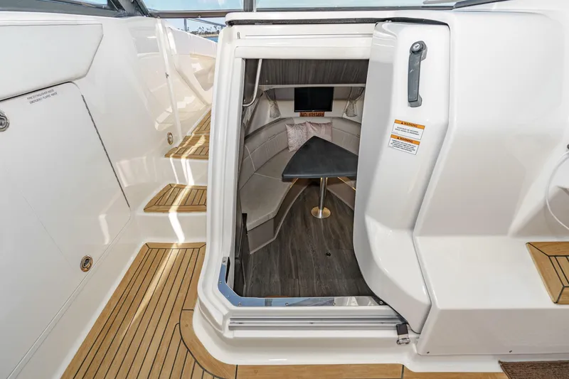 Slide: The Image of 2021 Sea Ray Sundancer 320 Outboard cabin interior with seating and table. - 44
