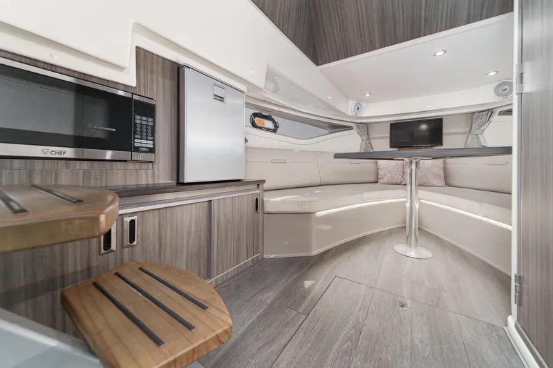 Slide: The Image of Interior of 2021 Sea Ray Sundancer 320 Outboard with modern seating and kitchenette. - 45