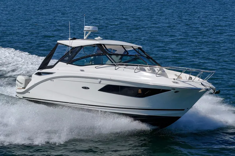 Slide: The Image of 2021 Sea Ray Sundancer 320 Outboard cruising on open water. - 5