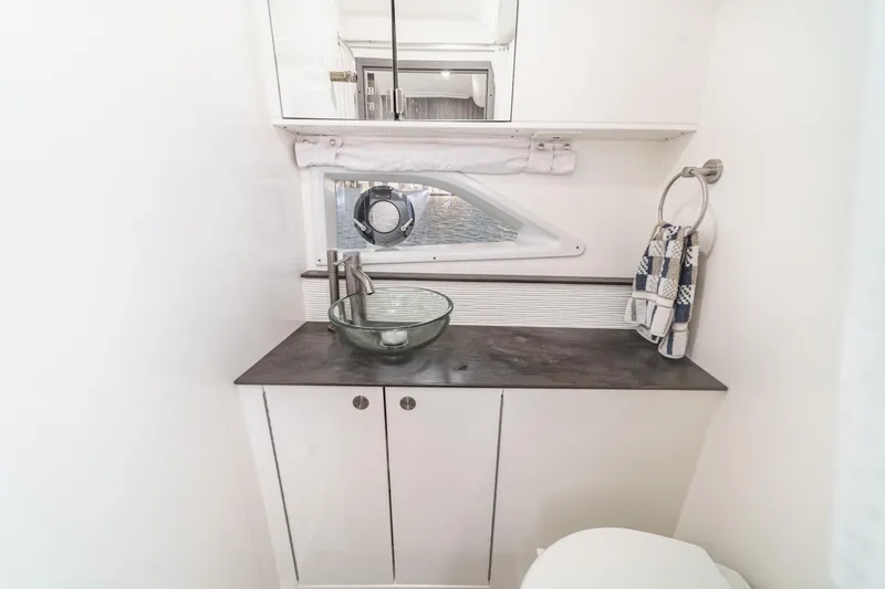 Slide: The Image of 2021 Sea Ray Sundancer 320 Outboard bathroom with modern sink and nautical decor. - 53