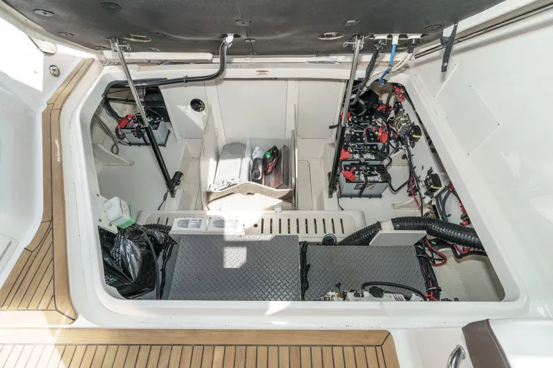 Slide: The Image of 2021 Sea Ray Sundancer 320 Outboard engine compartment with batteries and wiring. - 54