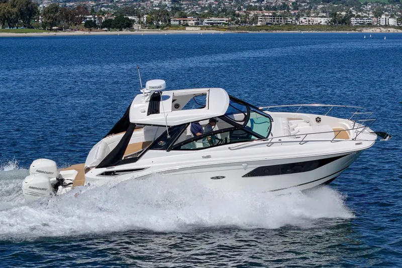 Slide: The Image of 2021 Sea Ray Sundancer 320 Outboard cruising on a scenic blue lake. - 8
