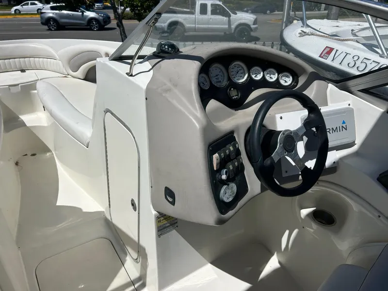 Slide: The Image of 2003 Stingray 240 LR boat interior with steering wheel and dashboard controls. - 11