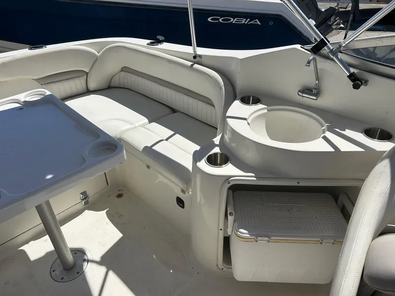 Slide: The Image of 2003 Stingray 240 LR boat interior with seating, table, and sink. - 24