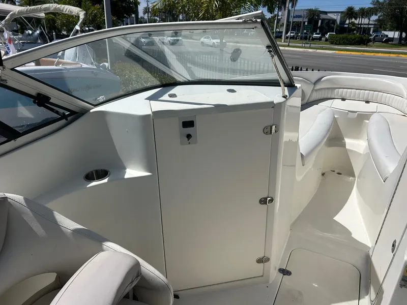 Slide: The Image of 2003 Stingray 240 LR boat interior with seating and storage compartment. - 26
