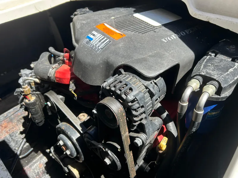 Slide: The Image of Engine compartment of a 2003 Stingray 240 LR boat, featuring a Volvo Penta engine. - 28