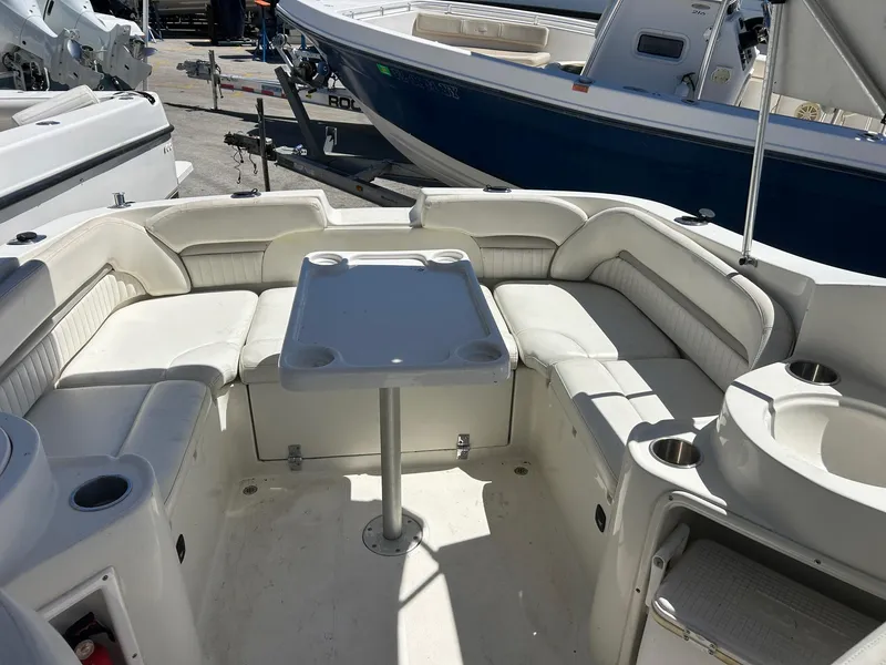 Slide: The Image of 2003 Stingray 240 LR boat interior with seating and table, ideal for leisure and relaxation. - 6