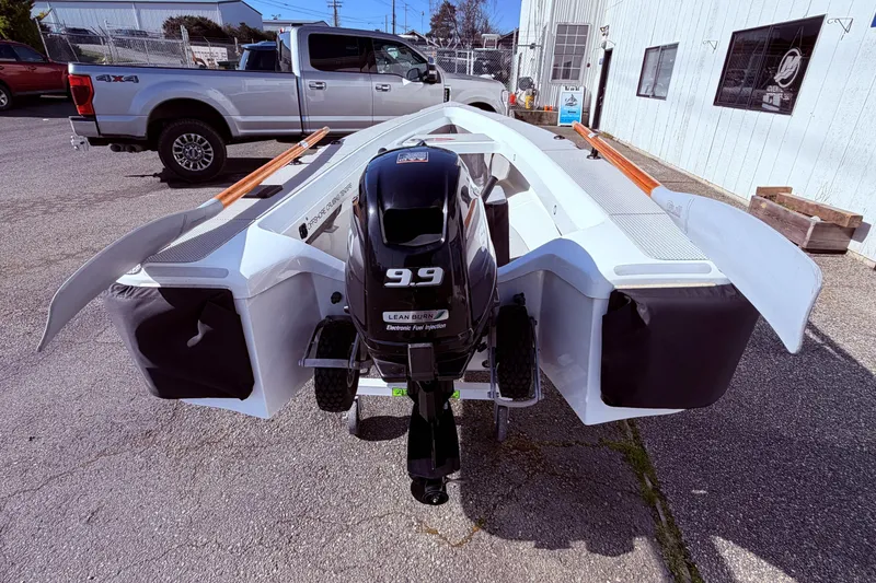 Slide: The Image of 2020 OC Tenders OC-300 boat with 9.9 HP engine, parked outdoors. - 12