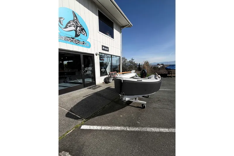 Slide: The Image of 2020 OC Tenders OC-300 boat outside Salish Boat Co. building on a sunny day. - 14