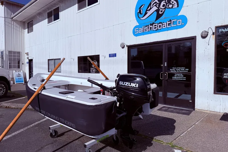 Slide: The Image of OC Tenders OC-300 boat with Suzuki motor outside Salish Boat Co. store. - 18