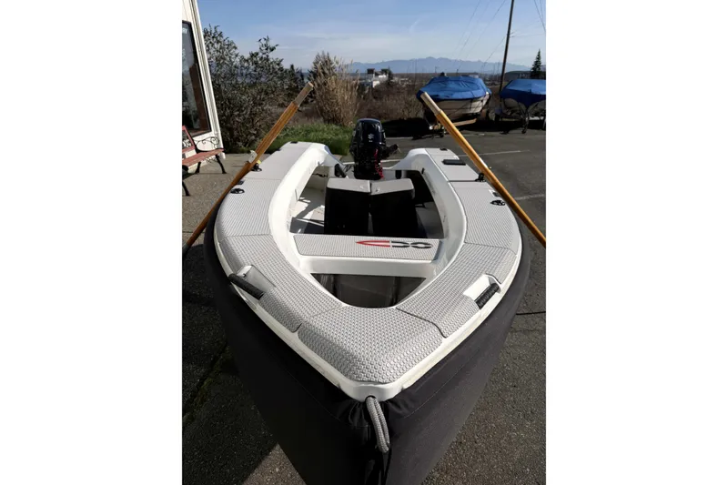 Slide: The Image of OC Tenders OC-300 boat, 2020 model, docked with oars and motor visible. - 4