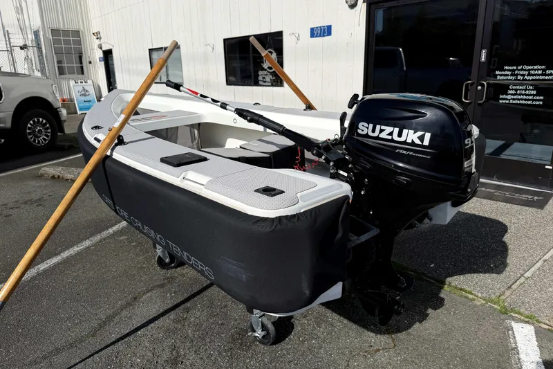 Slide: The Image of 2020 OC Tenders OC-300 boat with Suzuki outboard motor, parked outside a building. - 7