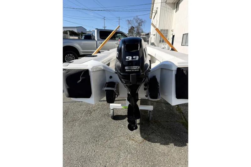 Slide: The Image of OC Tenders OC-300 boat with 9.9 horsepower engine, 2020 model, parked outdoors. - 8