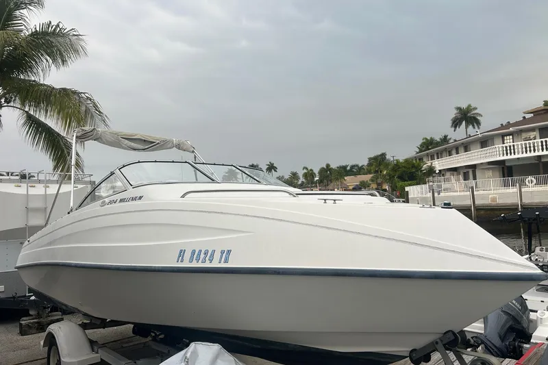 The Image of 2001 Sea Fox 204 Millennium boat on trailer, palm trees and waterfront homes in background. - 0