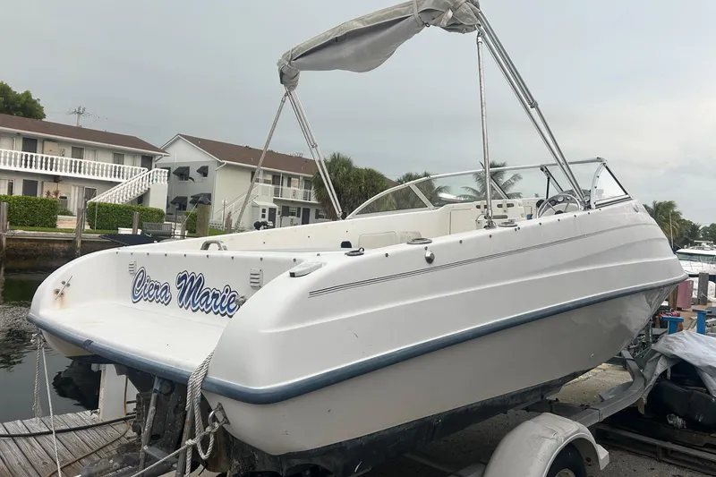 Slide: The Image of 2001 Sea Fox 204 Millenium boat on trailer, docked near waterfront homes. - 2
