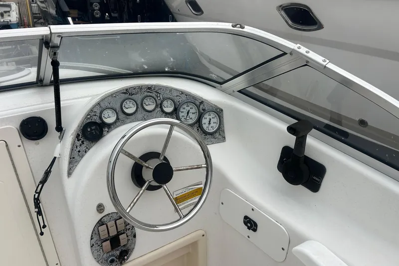 Slide: The Image of 2001 Sea Fox 204 Millenium boat dashboard with steering wheel and gauges. - 5
