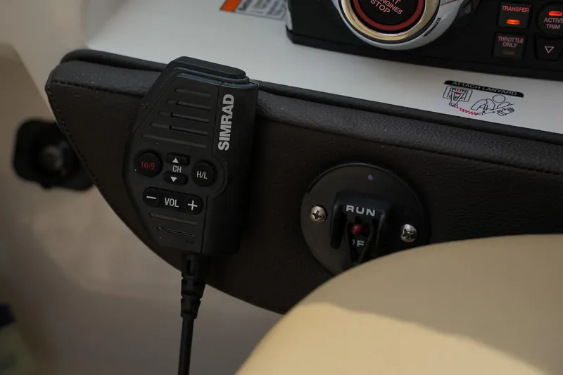 Slide: The Image of Simrad radio control on 2023 Sea Ray SLX 310 boat dashboard. - 16