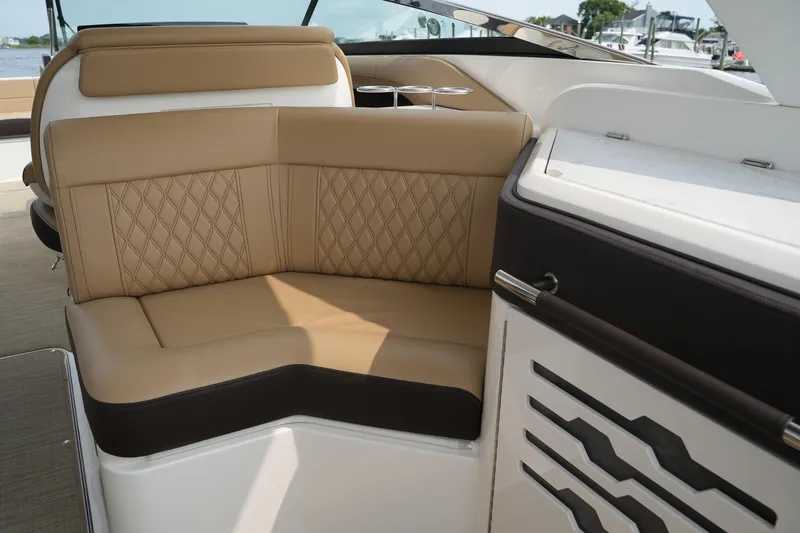 Slide: The Image of 2023 Sea Ray SLX 310 boat interior with tan leather seating and modern design. - 23