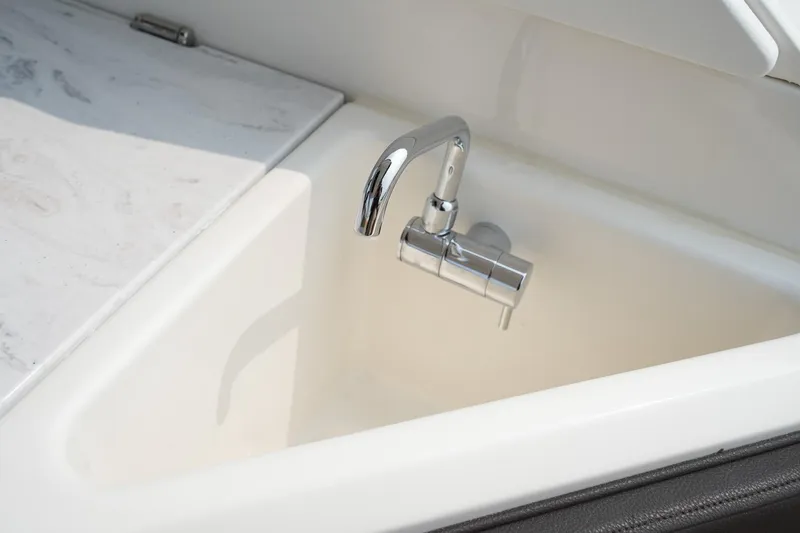 Slide: The Image of 2023 Sea Ray SLX 310 boat sink with chrome faucet. - 25