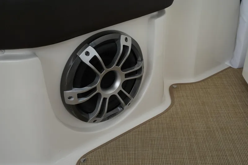 Slide: The Image of Speaker on 2023 Sea Ray SLX 310 boat, beige interior, close-up view. - 34