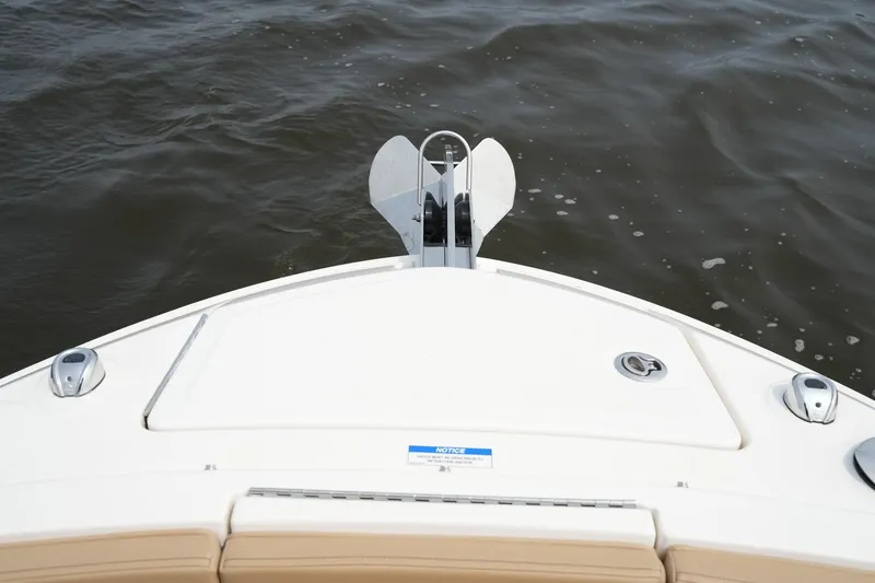 Slide: The Image of 2023 Sea Ray SLX 310 boat bow with anchor on calm water. - 35