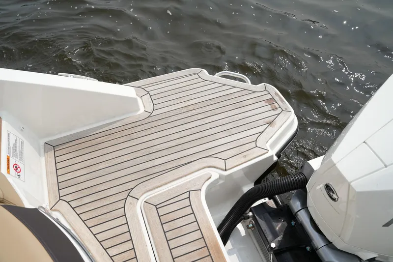 Slide: The Image of 2023 Sea Ray SLX 310 swim platform with teak decking on water. - 37