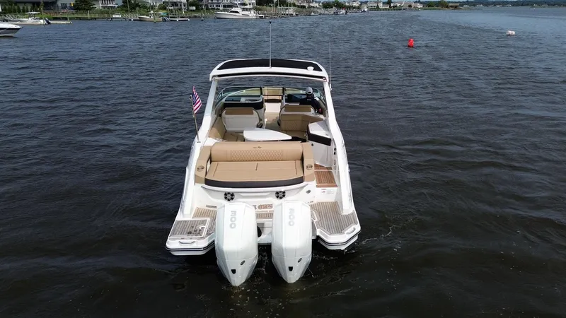 Slide: The Image of 2023 Sea Ray SLX 310 boat on water, rear view with twin engines. - 5