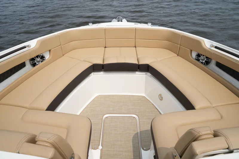Slide: The Image of 2023 Sea Ray SLX 310 boat with luxurious tan seating and spacious deck. - 7