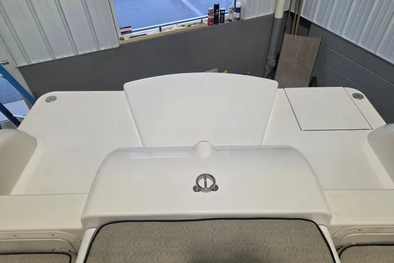 Slide: The Image of 2010 Westport 23 Bow Rider Tender boat interior, featuring a sleek white deck design. - 11