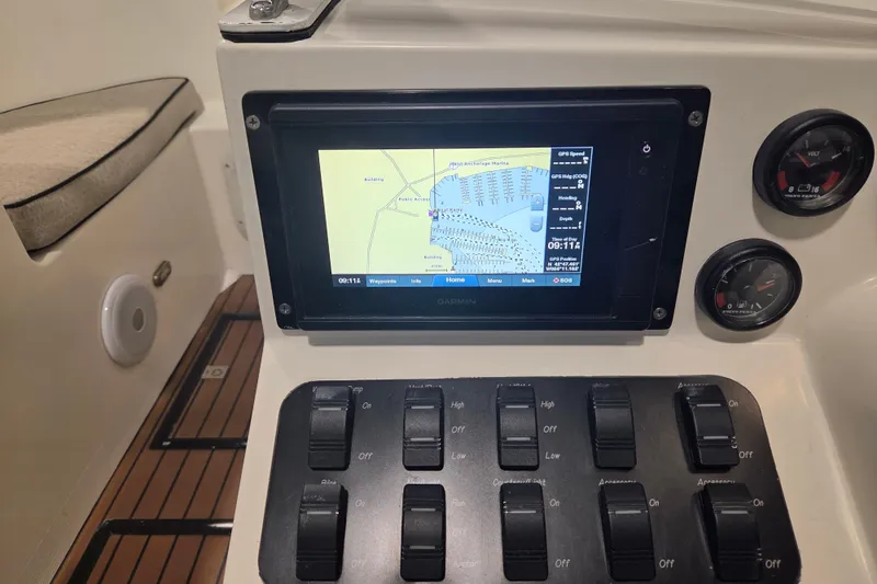 Slide: The Image of Control panel of a 2010 Westport 23 Bow Rider Tender with GPS display and switches. - 13