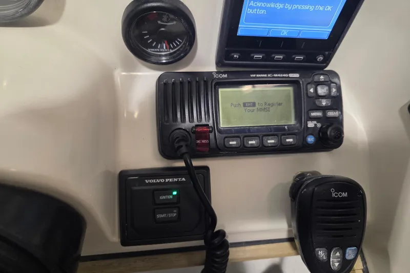 Slide: The Image of Control panel of a 2010 Westport 23 Bow Rider Tender with Icom VHF radio and Volvo Penta ignition. - 17