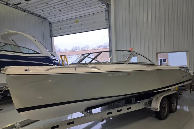 Slide: The Image of 2010 Westport 23 Bow Rider Tender on trailer in indoor storage facility. - 2