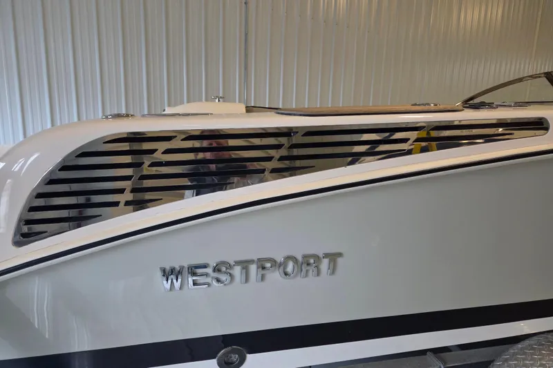 Slide: The Image of 2010 Westport 23 Bow Rider Tender with sleek design in a storage facility. - 26
