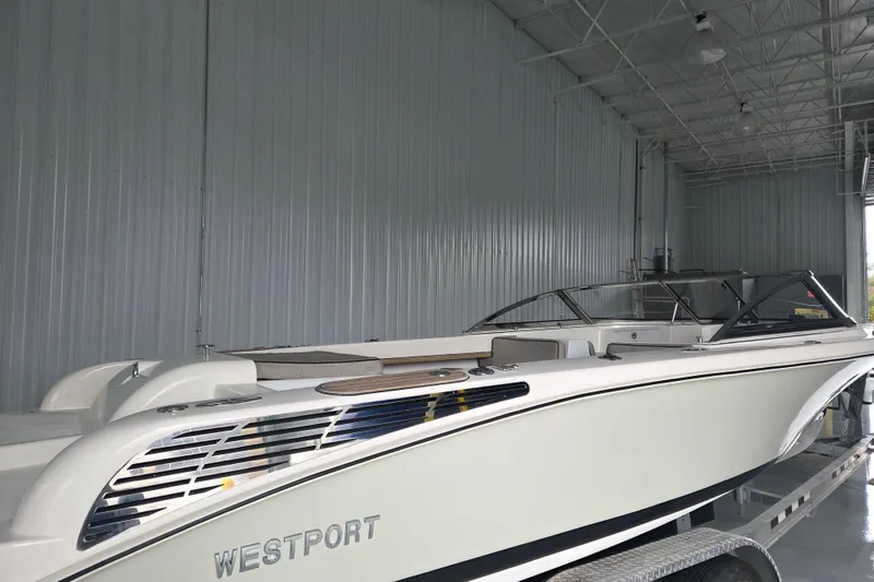 Slide: The Image of 2010 Westport 23 Bow Rider Tender in a spacious indoor storage facility. - 27