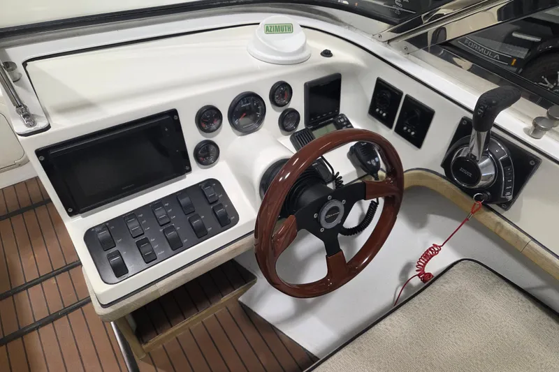 Slide: The Image of Cockpit of 2010 Westport 23 Bow Rider Tender with steering wheel and control panel. - 4